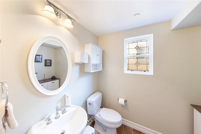 a white toilet sitting next to a bathroom sink