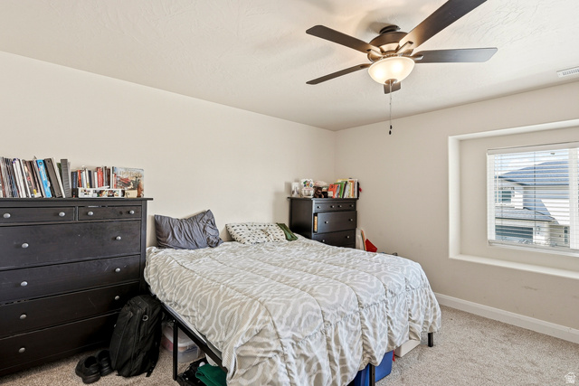 668 East Fiddlers Canyon Road, Unit 6 Cedar City, UT 84721 - Photo 15 of 36 Neutral-toned bedroom featuring a textured ceiling, a ceiling fan with integrated lighting, and a single window with blinds