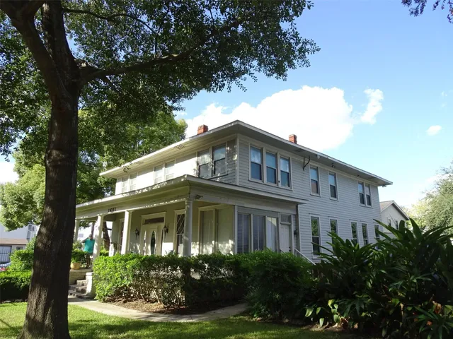 a front view of a house with yard and green space