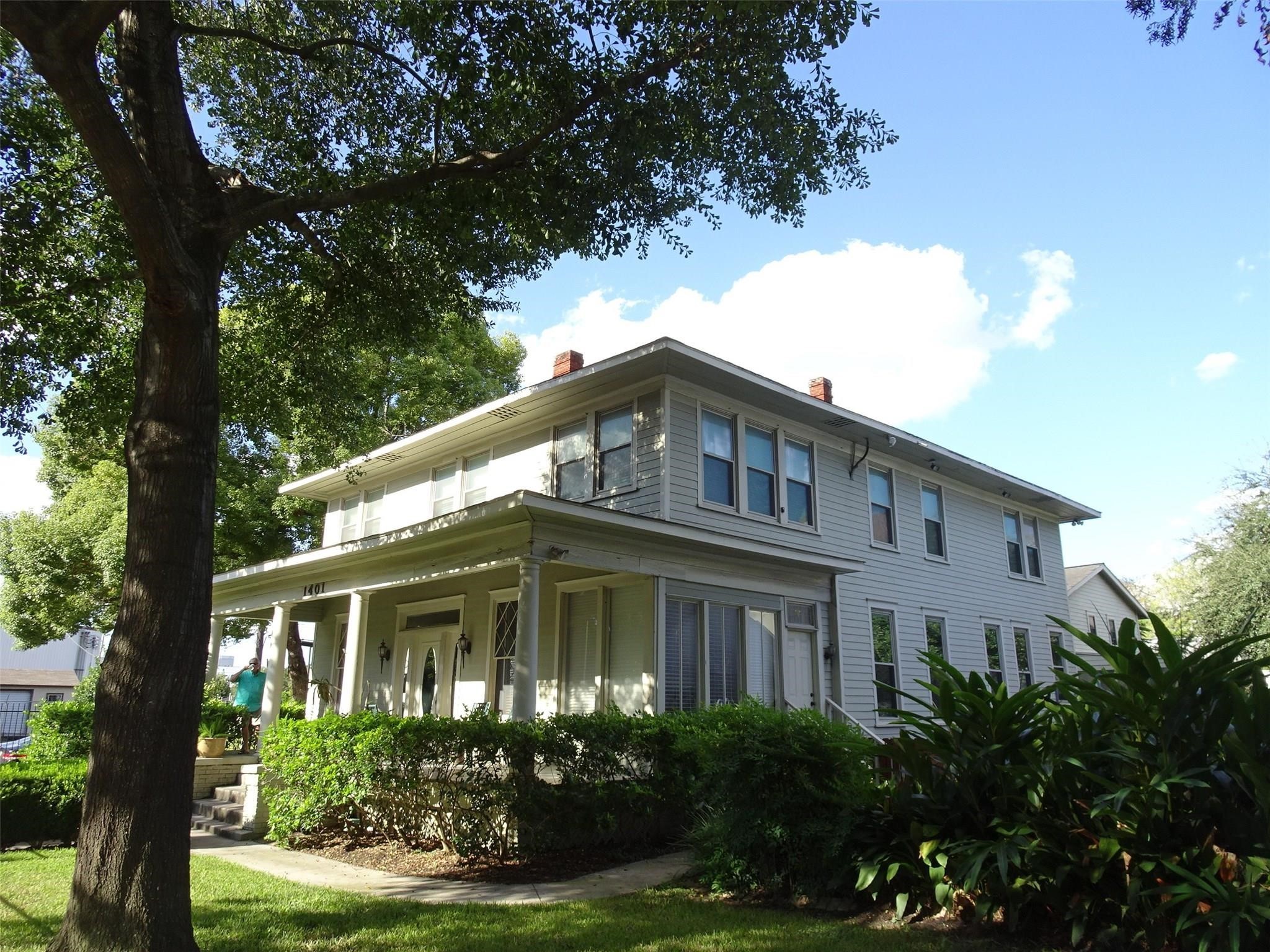 a front view of a house with yard and green space