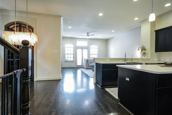 an empty room with wooden floor door and windows