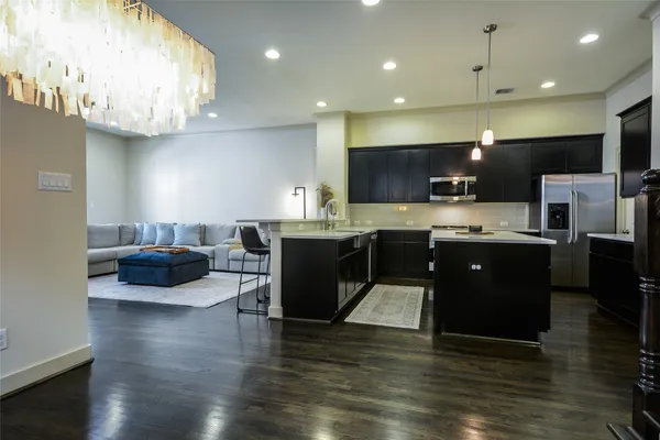 a kitchen with stainless steel appliances a sink and a microwave