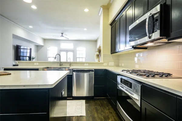 a kitchen with lots of counter space a sink and chairs