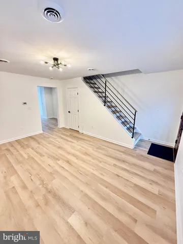 a view of a room with a ceiling fan