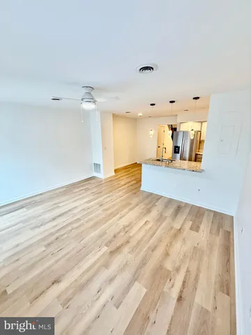 a view of a kitchen with a sink and cabinets