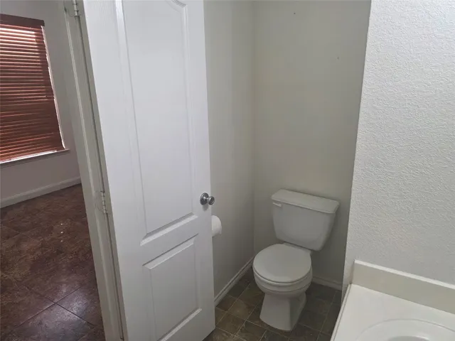 a white toilet sitting next to a sink