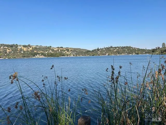 a view of a lake with houses in the back