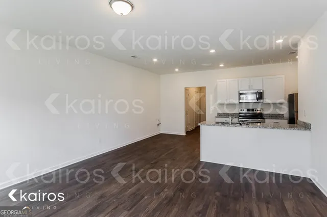 a kitchen with granite countertop a refrigerator and a stove