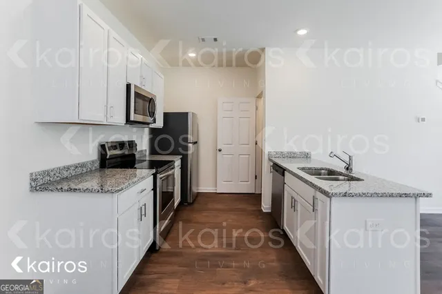 a kitchen with stainless steel appliances granite countertop a stove and a sink