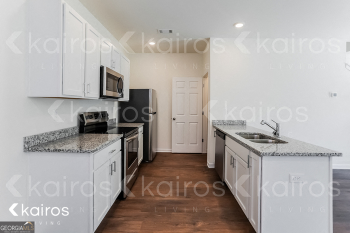 114 Dudley Way Southwest Cartersville, GA 30120 - Photo 4 of 17 a kitchen with stainless steel appliances granite countertop a stove and a sink