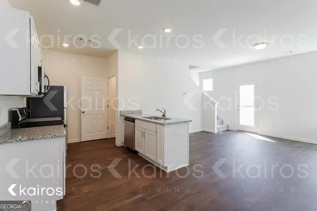 a kitchen with a sink appliances and cabinets