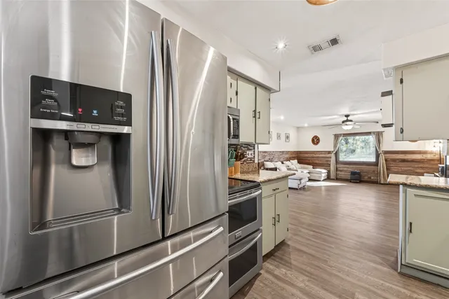 a kitchen with stainless steel appliances a refrigerator stove and sink