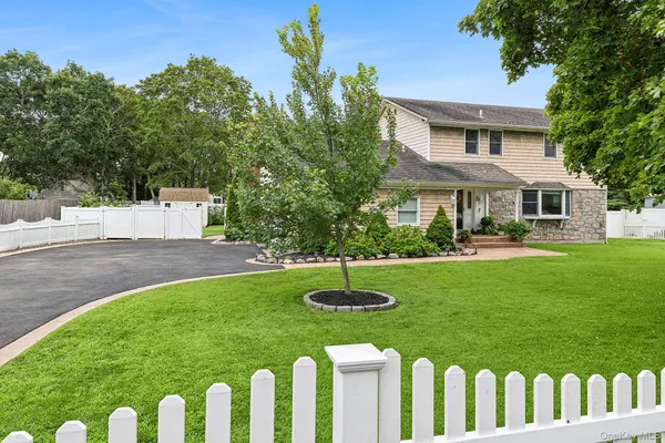 a front view of a house with a garden