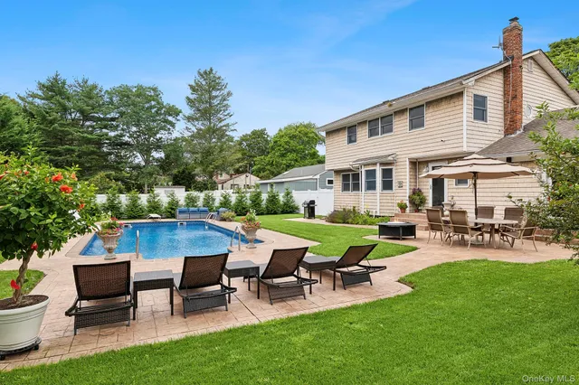 a view of a house with backyard sitting area and garden