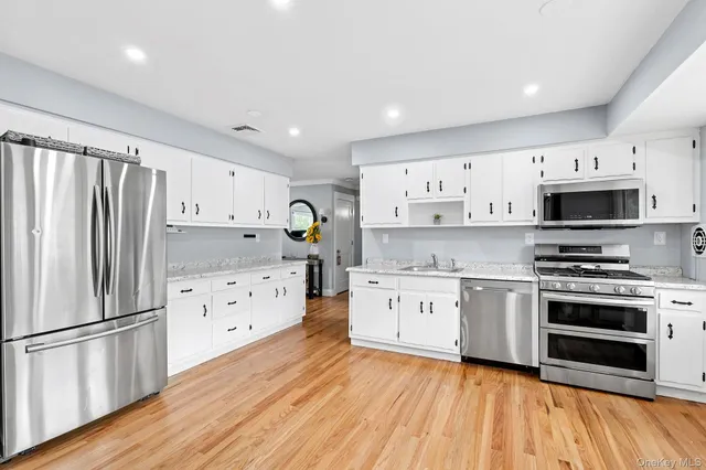a kitchen with stainless steel appliances a stove sink and refrigerator