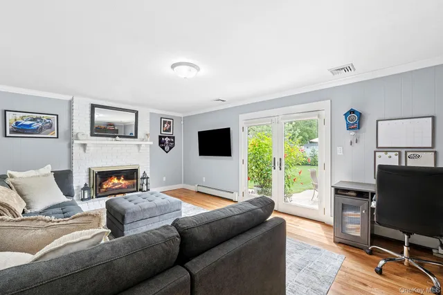 a living room with furniture a flat screen tv and a fireplace