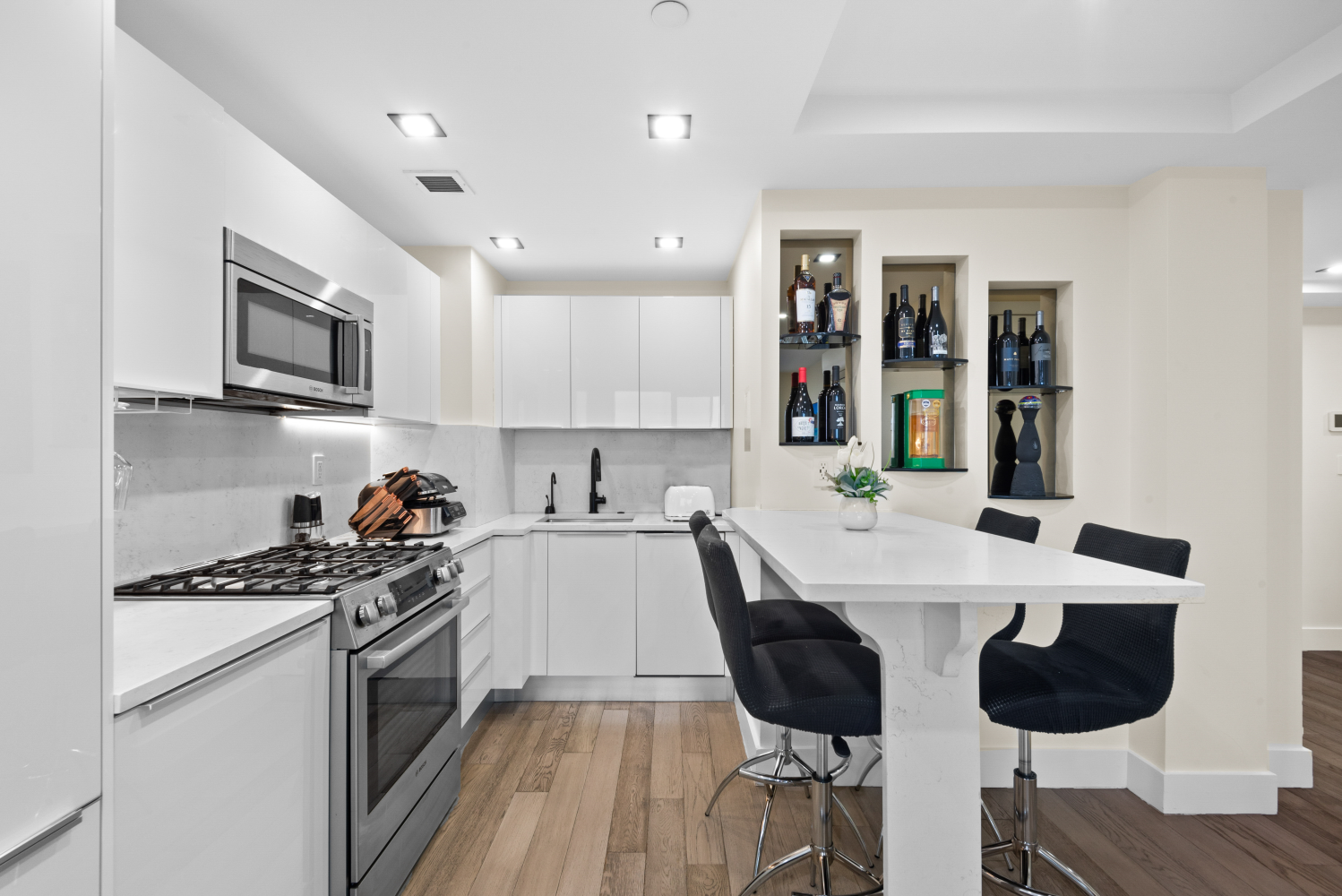 a kitchen with a dining table cabinets and appliances