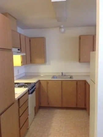a kitchen with granite countertop a sink and a stove