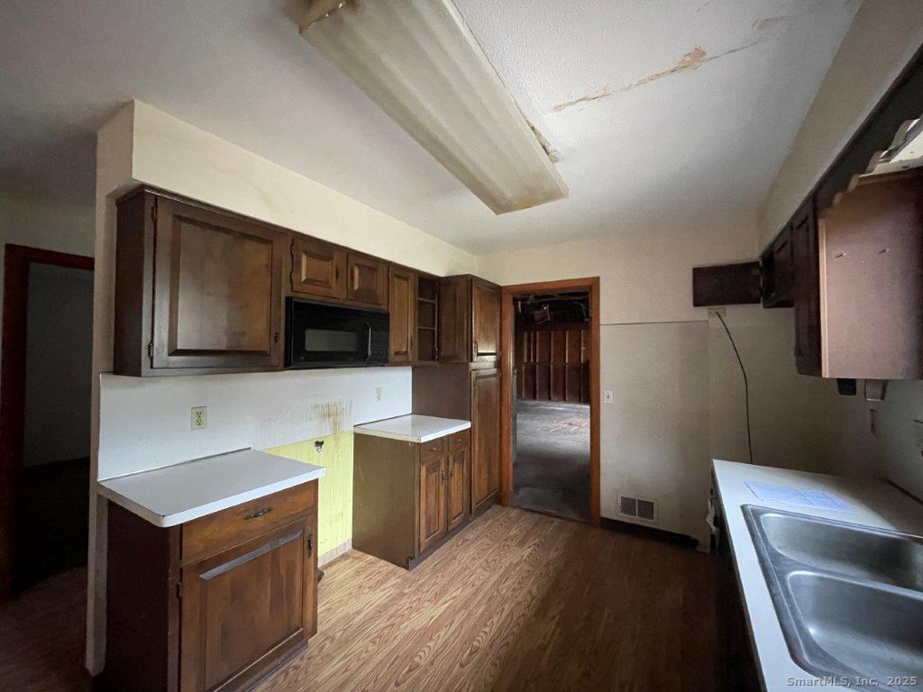 3 Medley Lane Clinton, CT 06413 - Photo 16 of 35 a kitchen with stainless steel appliances wooden cabinets and granite counter tops