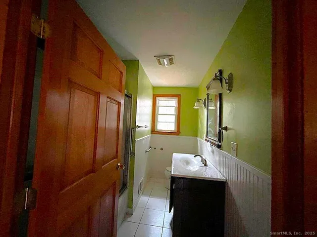 a bathroom with a sink and mirror