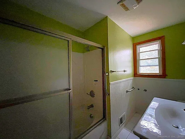 a bathroom with a bathtub and shower