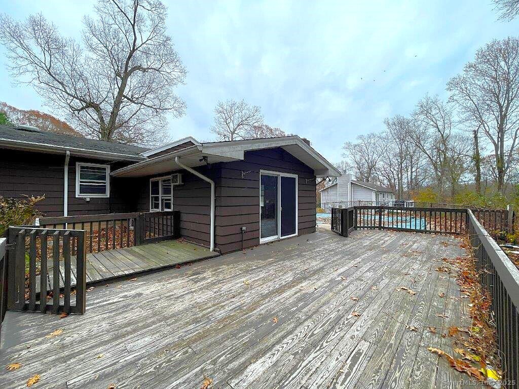 3 Medley Lane Clinton, CT 06413 - Photo 7 of 35 a view of a house with wooden deck and a large window