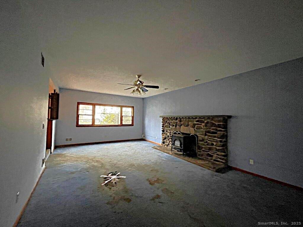 3 Medley Lane Clinton, CT 06413 - Photo 10 of 35 an empty room with windows and fireplace