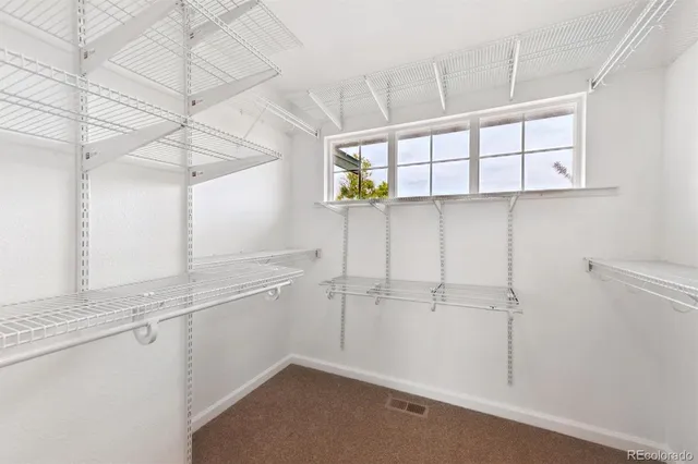 a bathroom with a granite countertop sink and a toilet