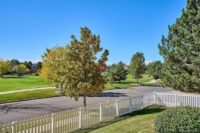 a view of a house with a yard and potted plants