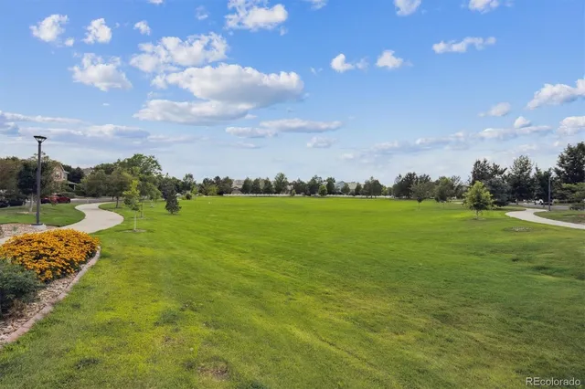 an aerial view of residential houses with outdoor space and trees