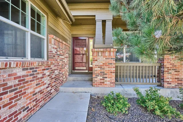 a view of front door of house with wooden fence