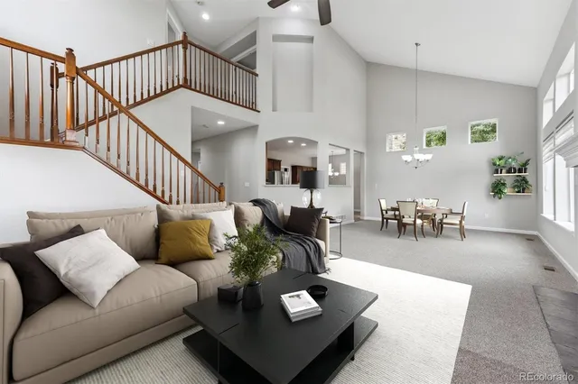 a view of a dining room with furniture and a chandelier