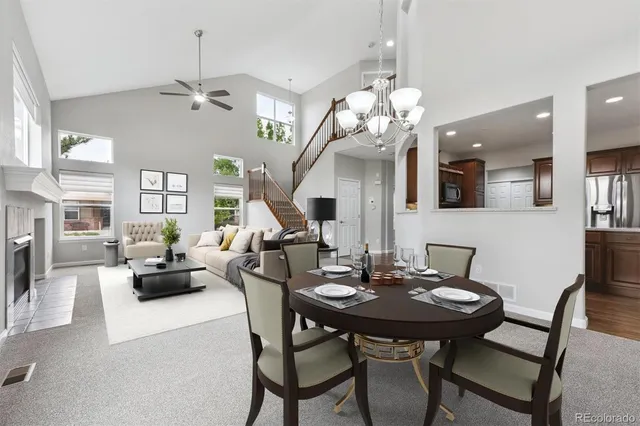 a kitchen with stainless steel appliances granite countertop a sink a stove a refrigerator cabinets and chairs