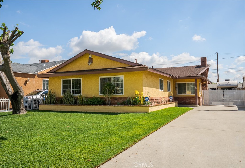 a front view of a house with a yard and porch