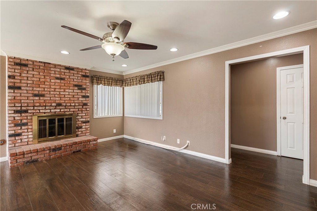 232 North Aspan Avenue Azusa, CA 91702 - Photo 15 of 29 an empty room with wooden floor fireplace and windows