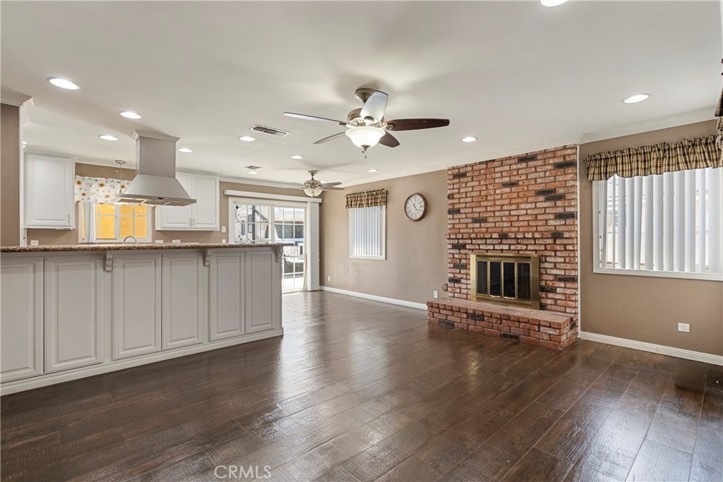 232 North Aspan Avenue Azusa, CA 91702 - Photo 16 of 29 a view of an empty room with a kitchen and wooden floor