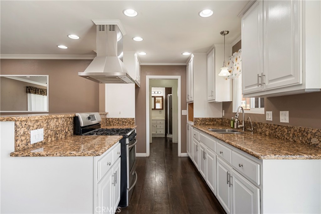 232 North Aspan Avenue Azusa, CA 91702 - Photo 18 of 29 a kitchen with granite countertop a sink stove and cabinets