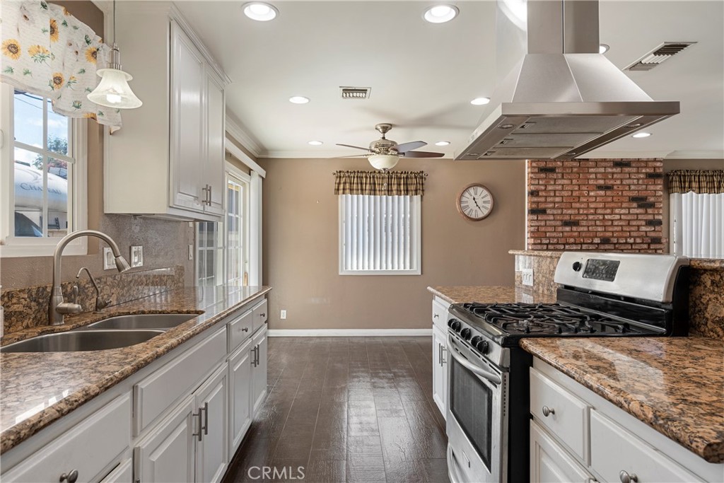 232 North Aspan Avenue Azusa, CA 91702 - Photo 21 of 29 a kitchen with stainless steel appliances granite countertop a sink stove and cabinets