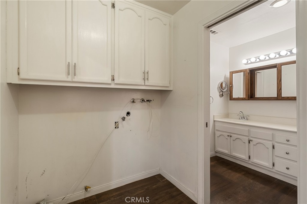 232 North Aspan Avenue Azusa, CA 91702 - Photo 23 of 29 a bathroom with a sink and a mirror