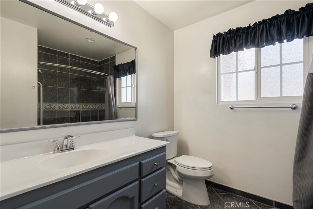 232 North Aspan Avenue Azusa, CA 91702 - Photo 5 of 29 a bathroom with a sink a toilet and shower