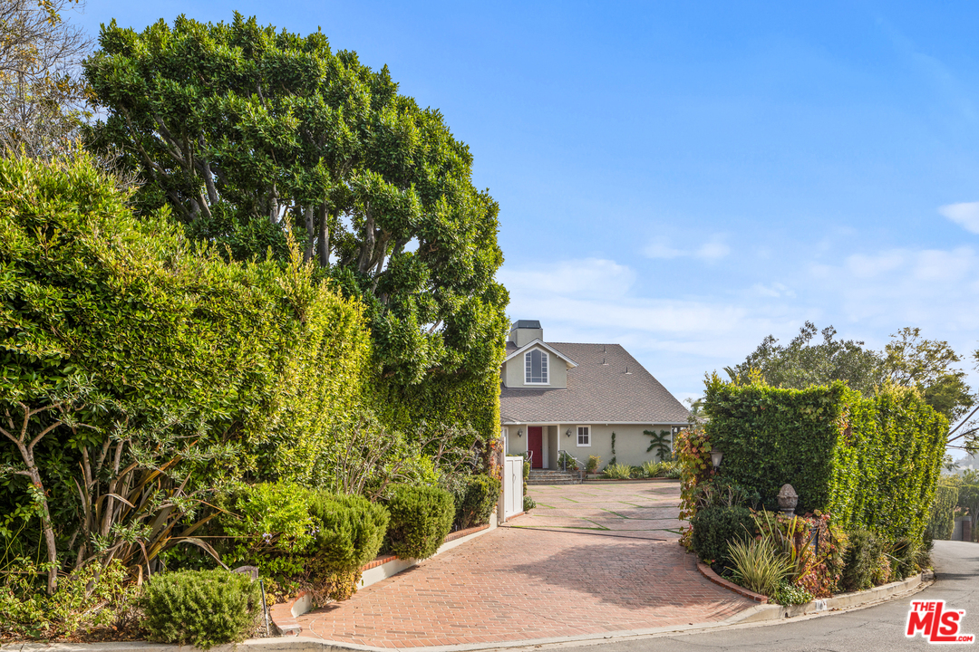 1110 Stradella Road Los Angeles, CA 90077 - Photo 2 of 28 a front view of a house with a garden
