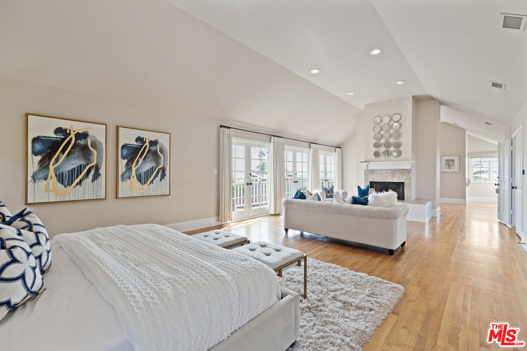 1110 Stradella Road Los Angeles, CA 90077 - Photo 13 of 28 a bedroom with a white bed a couch and dresser