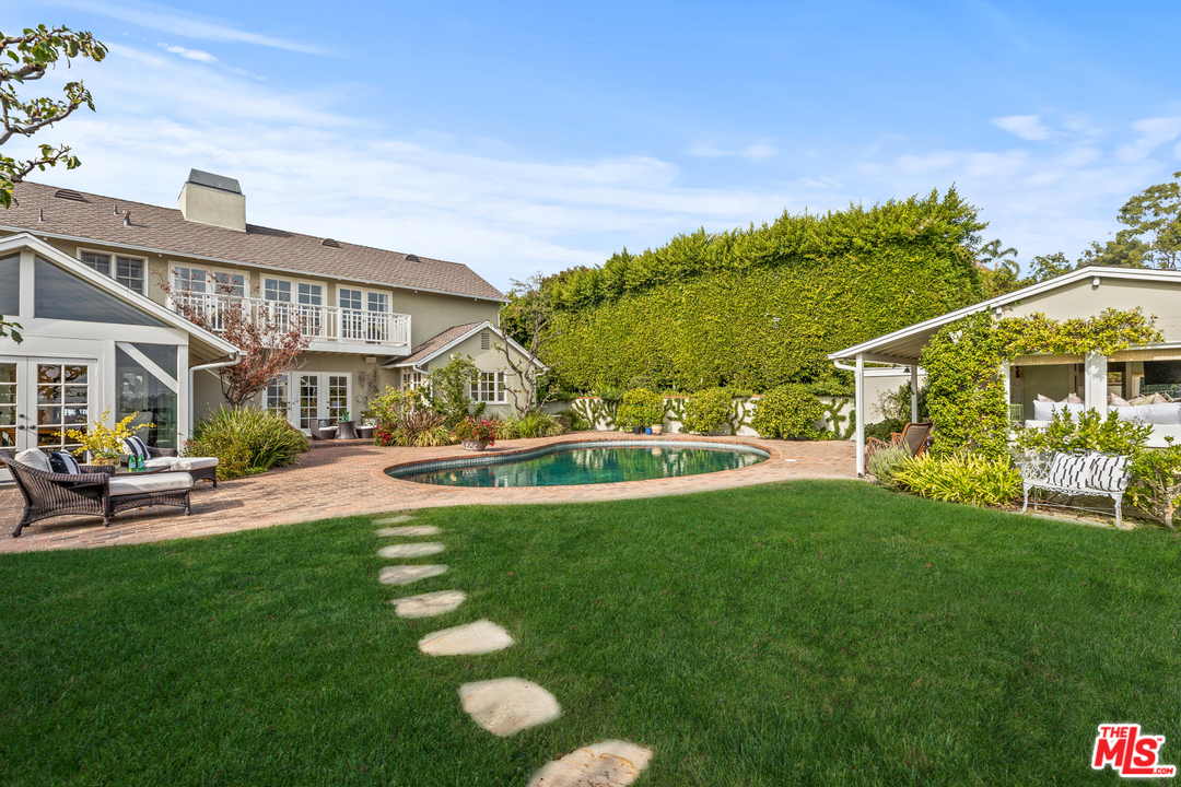 1110 Stradella Road Los Angeles, CA 90077 - Photo 18 of 28 a view of a house with a yard porch and sitting area