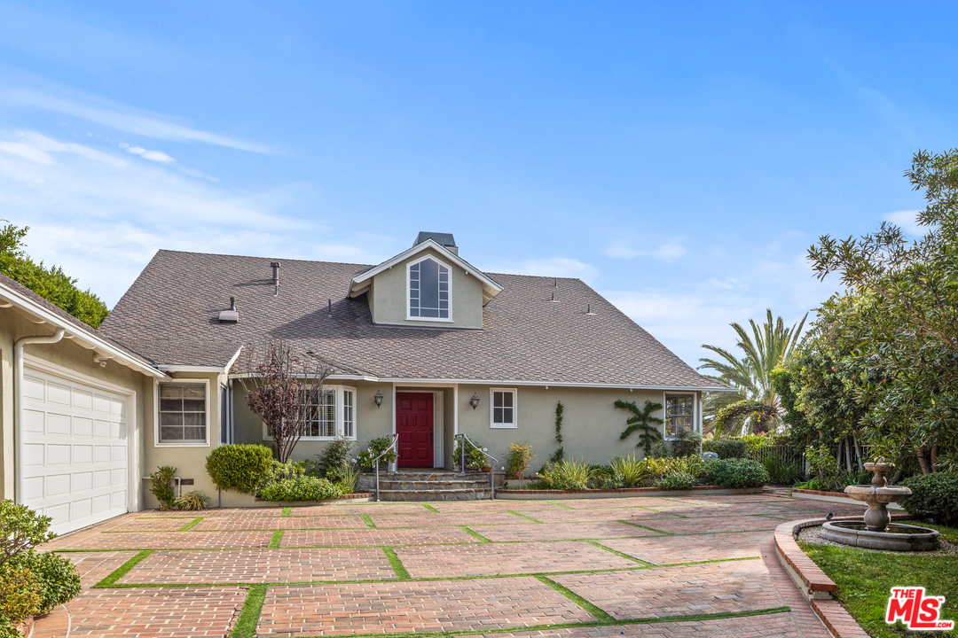 1110 Stradella Road Los Angeles, CA 90077 - Photo 3 of 28 a front view of a house with a yard