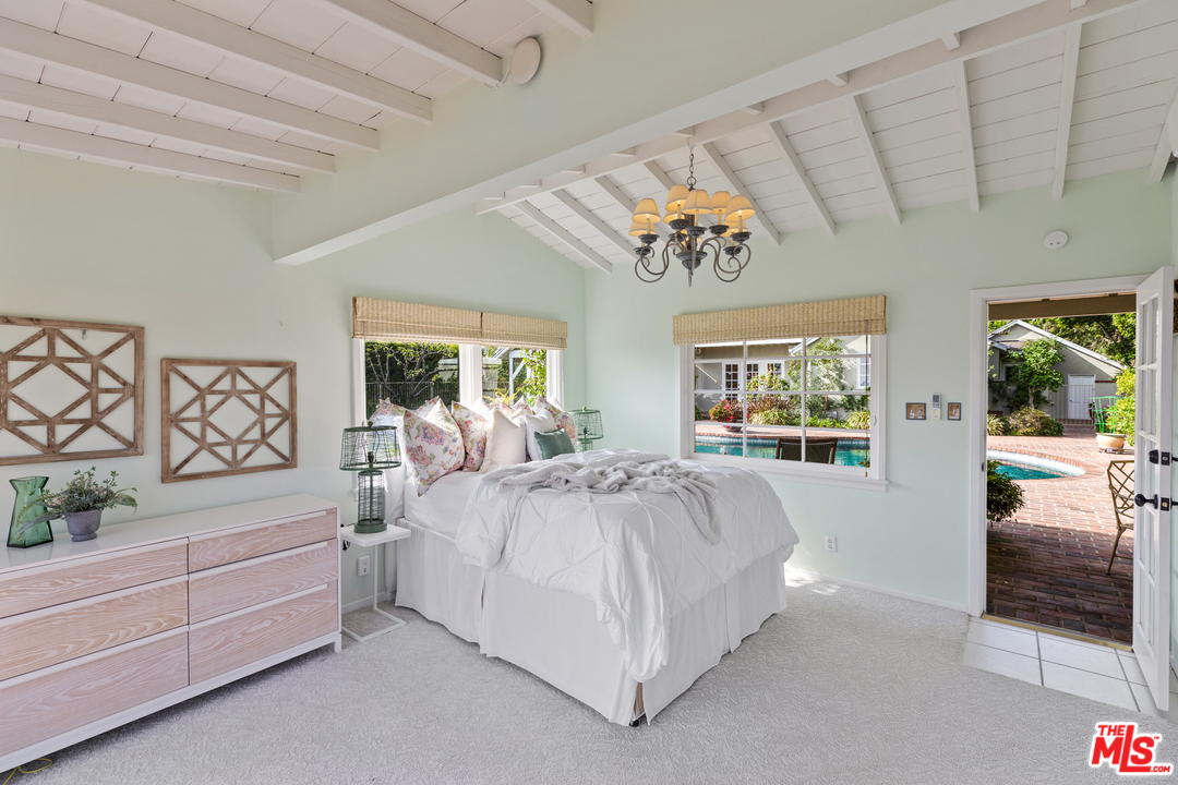 1110 Stradella Road Los Angeles, CA 90077 - Photo 21 of 28 a bed room with a bed and a large window