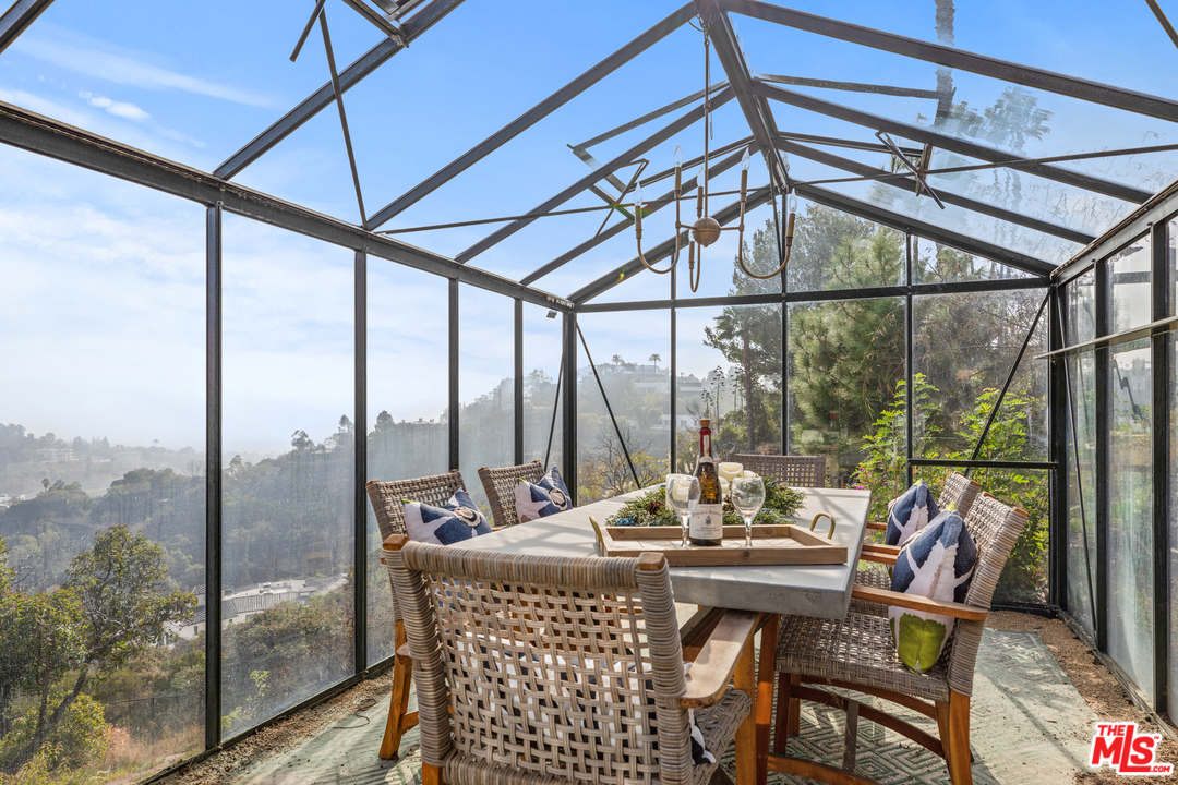 1110 Stradella Road Los Angeles, CA 90077 - Photo 26 of 28 a view of a dining room with furniture window and outside view