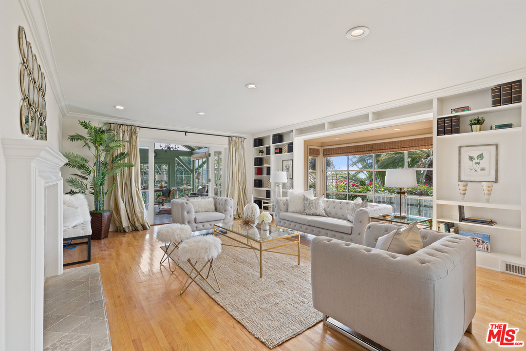1110 Stradella Road Los Angeles, CA 90077 - Photo 5 of 28 a living room with furniture large windows and wooden floor