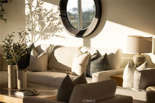 a living room with furniture and a mirror