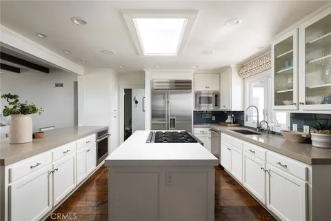 a kitchen with sink a stove and cabinets