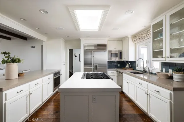a kitchen with sink a stove and cabinets